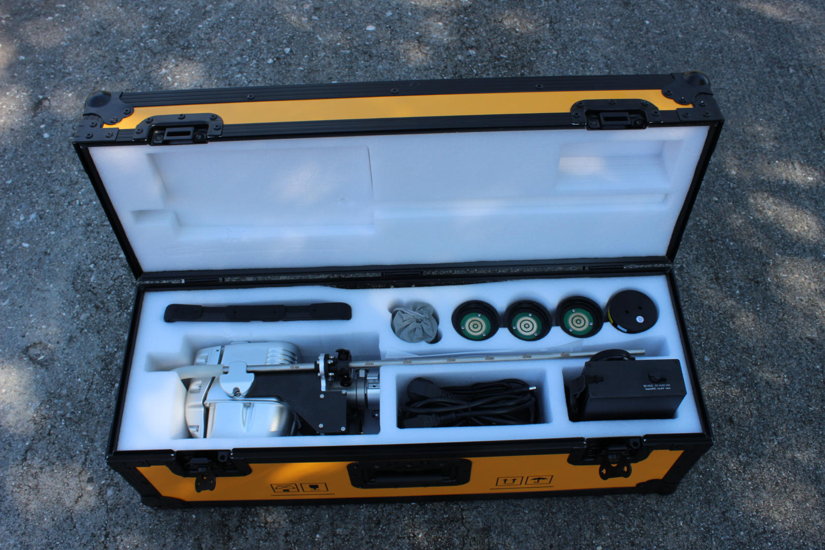 A yellow and black case with tools inside of it.